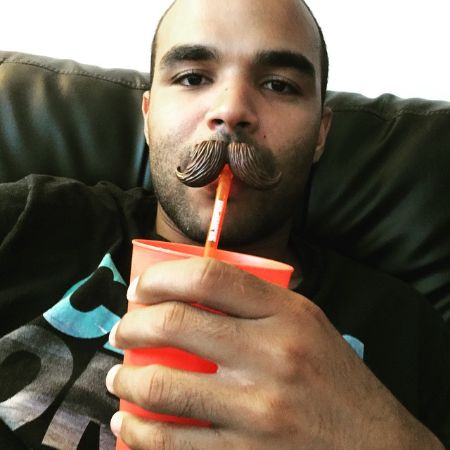 Justin Ryan Simpson took a picture with a drink in his hand.